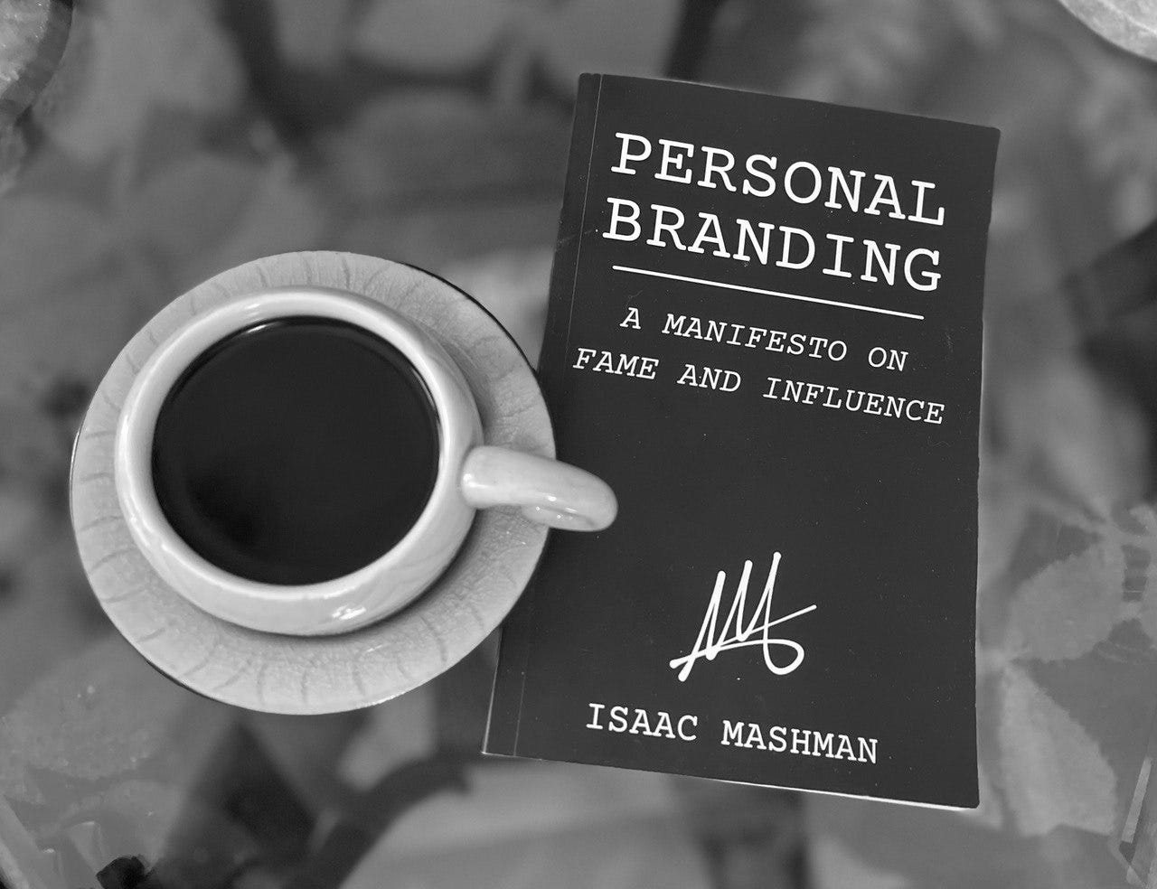 The First Edition of Personal Branding: A Manifesto on Fame and Influence beside an espresso