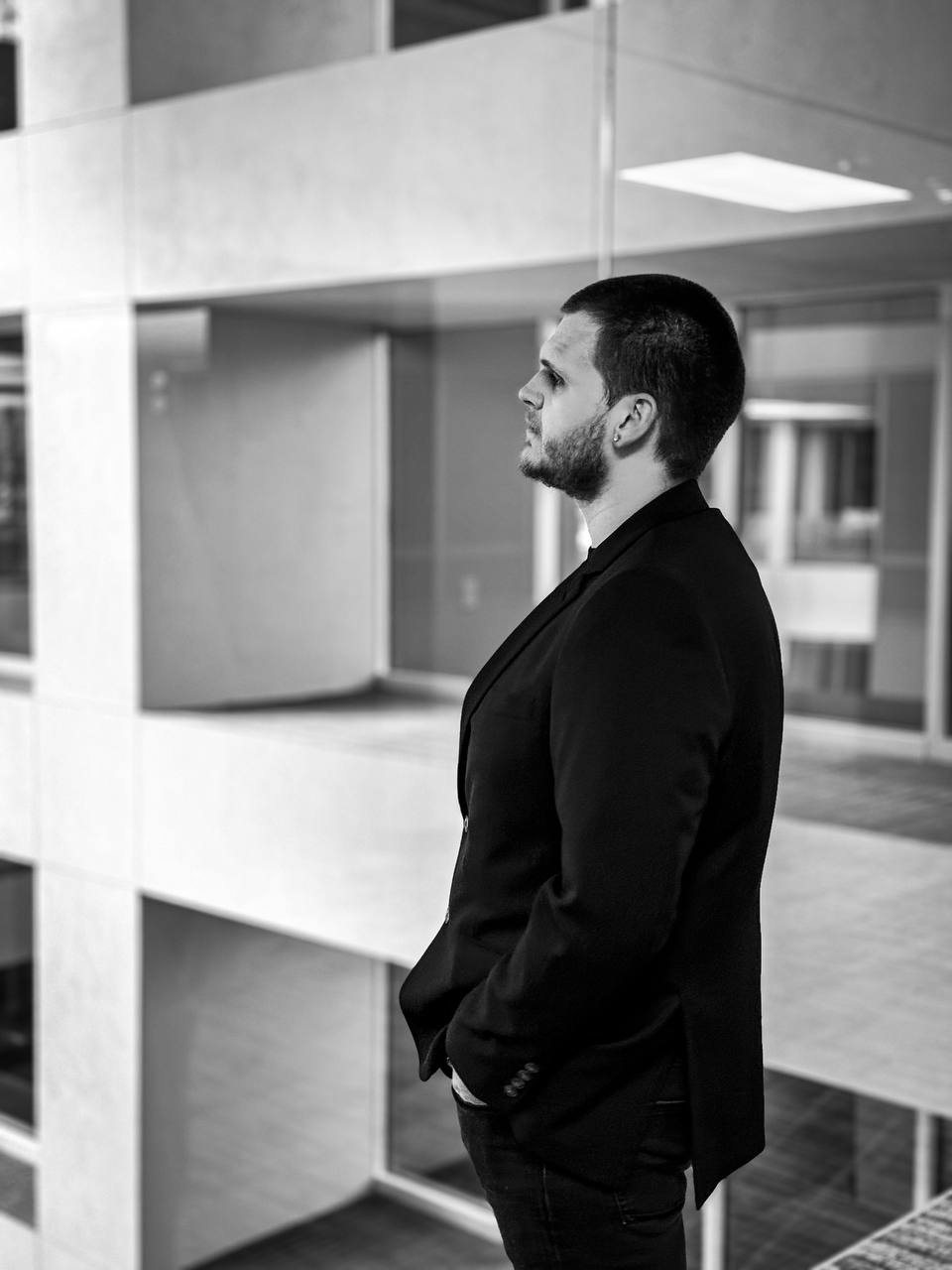 Isaac Mashman in profile in an office atrium