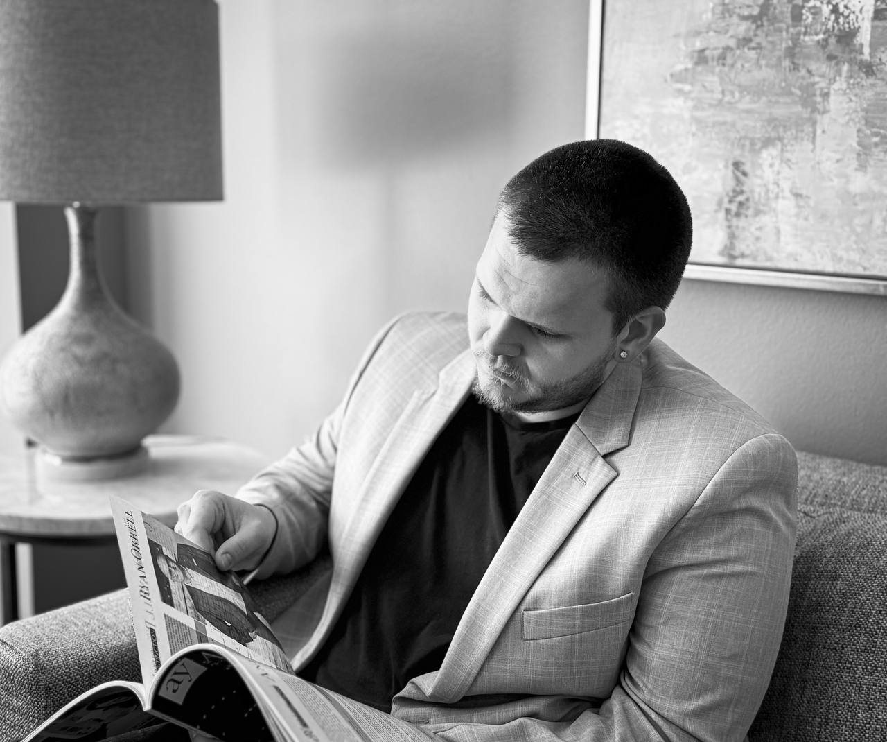 Isaac Mashman reading a magazine feature