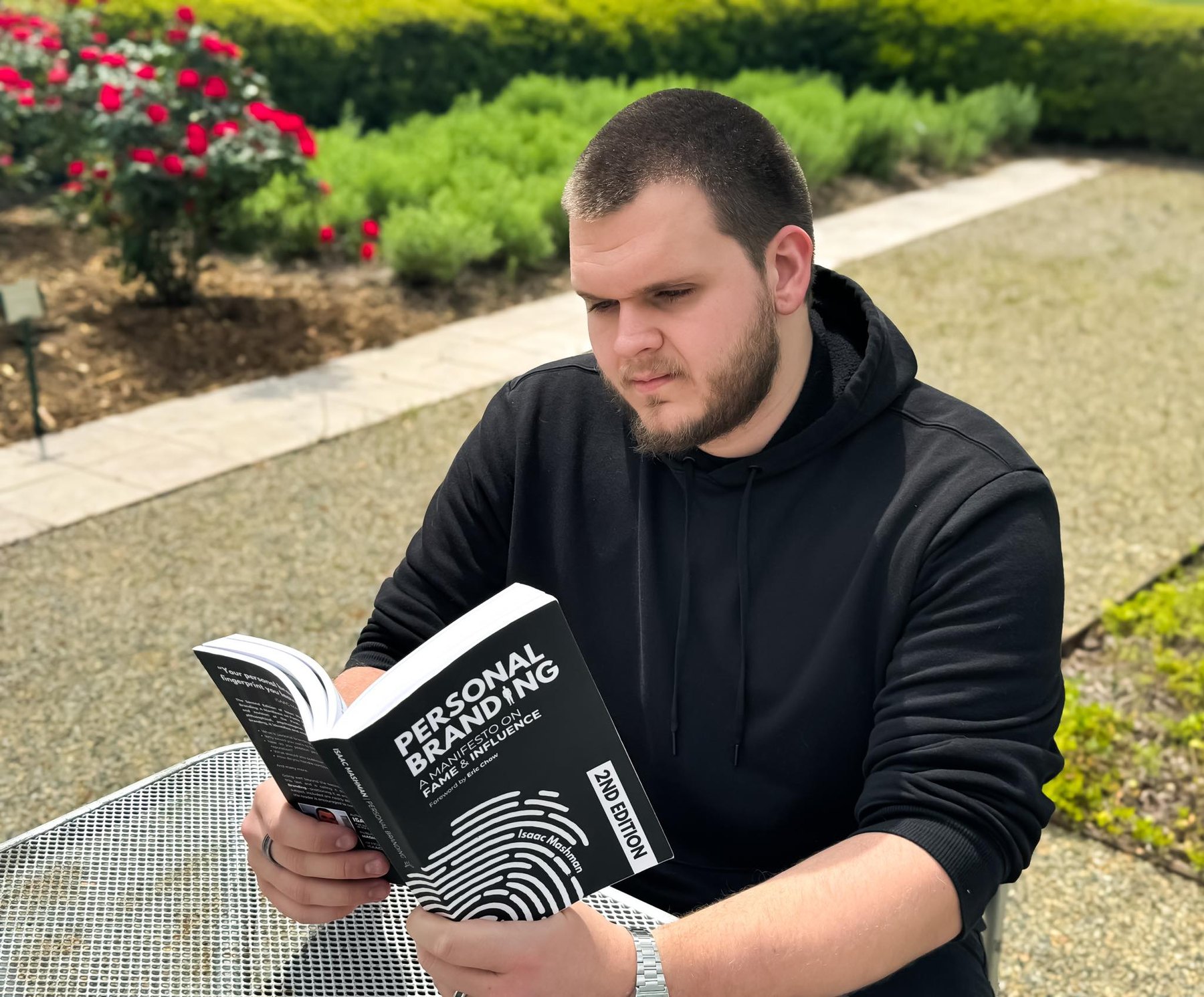 Isaac Mashman reading the second edition of Personal Branding: A Manifesto on Fame and Influence